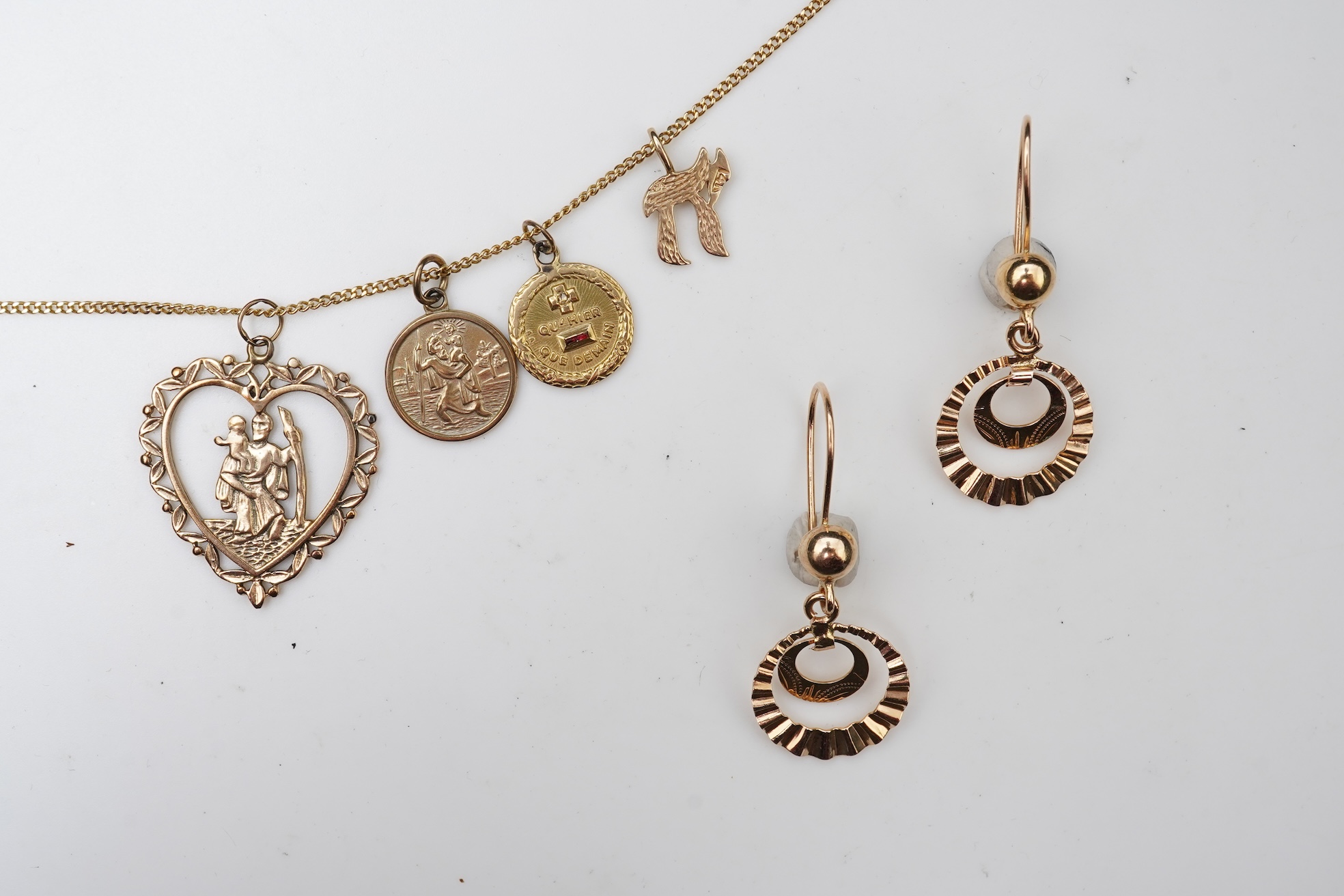 A gold necklace and pair of earrings